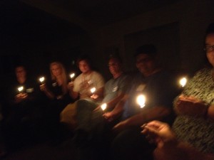 group holding lit candles